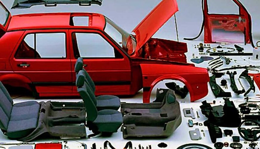 Dismantled red car with the used car parts displayed