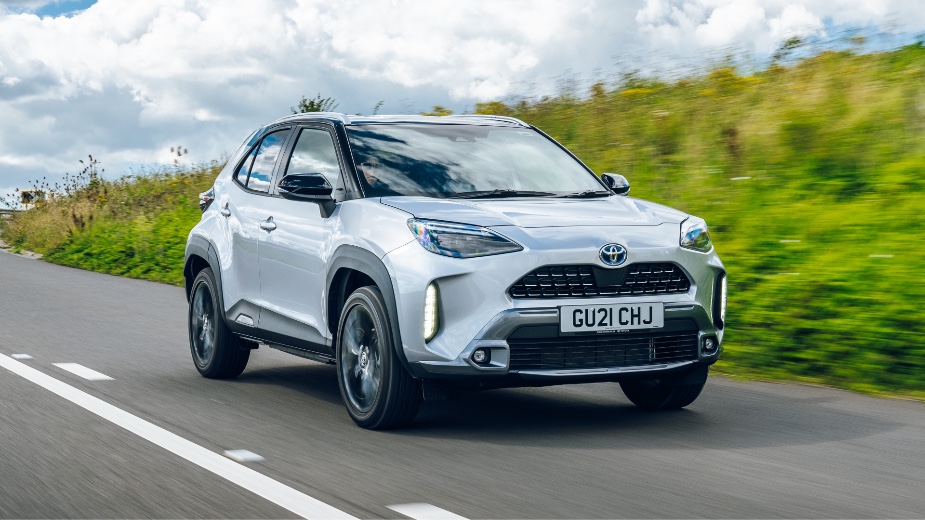 A grey Toyota Yaris Cross on a countryside road, one of the best-selling brands in Europe