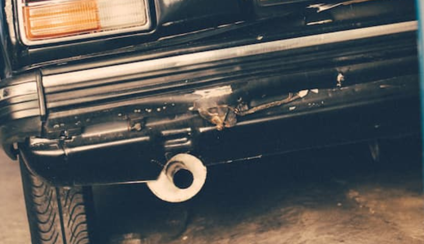 Backside of a car with exhaust pipe and particulate filter