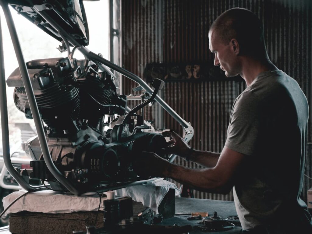 Man repairing an engine of a car