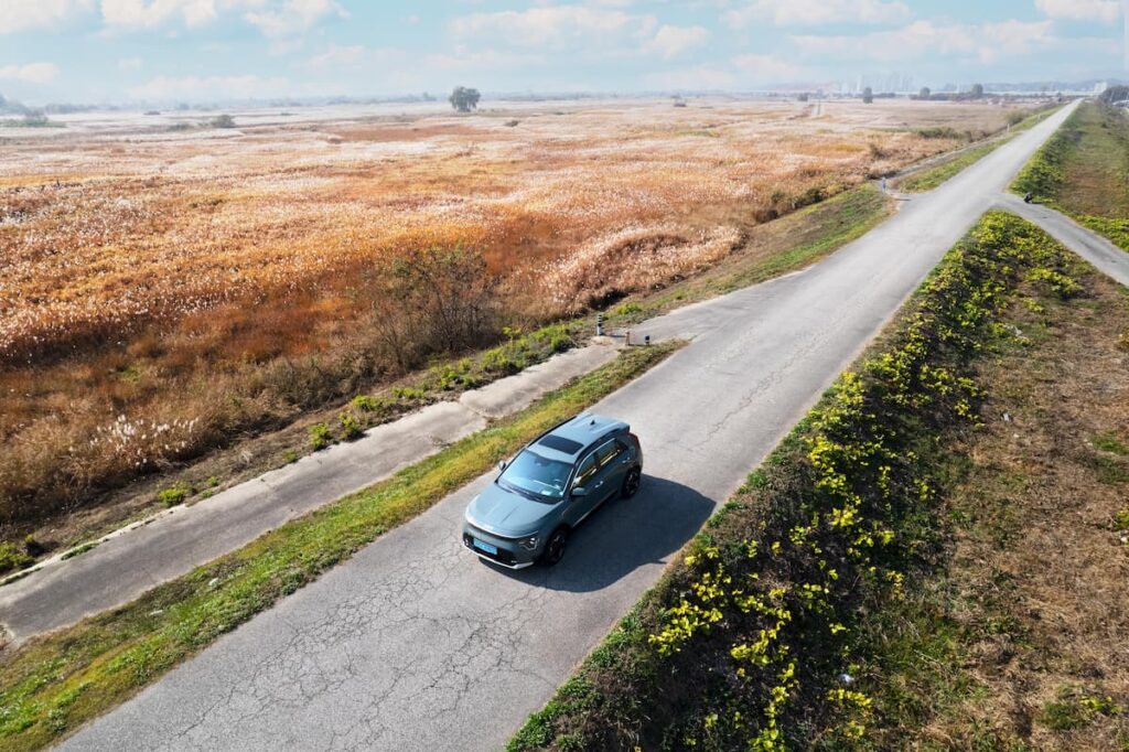 Car driving on a deserted road while using eco mode.